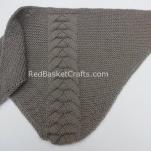 Triangle Shawl Knitted in Garter and Braid Stitches from Chunky Wool Yarn to illustrate a Free Knitting Pattern.