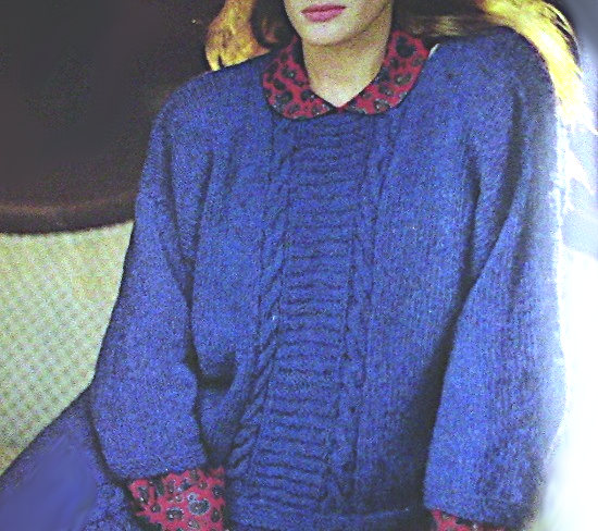 Woman wearing a blue long- sleeve pullover with a vertical panel knitted in cable and ladder stitches in the center front - Vintage knitting pattern for worsted yarn.